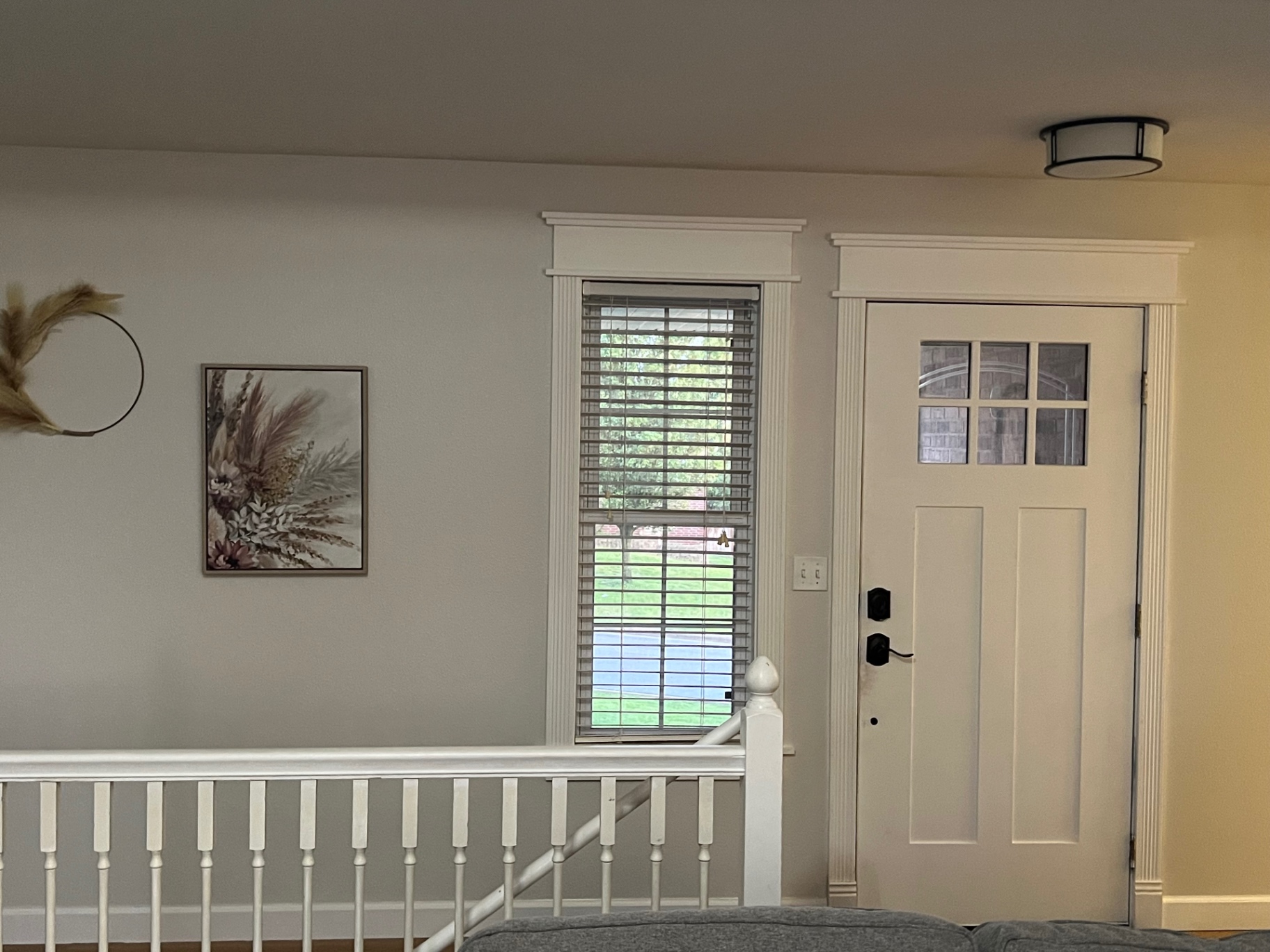 Finished craftsman entry door and window casing painted white near Springfield, MO