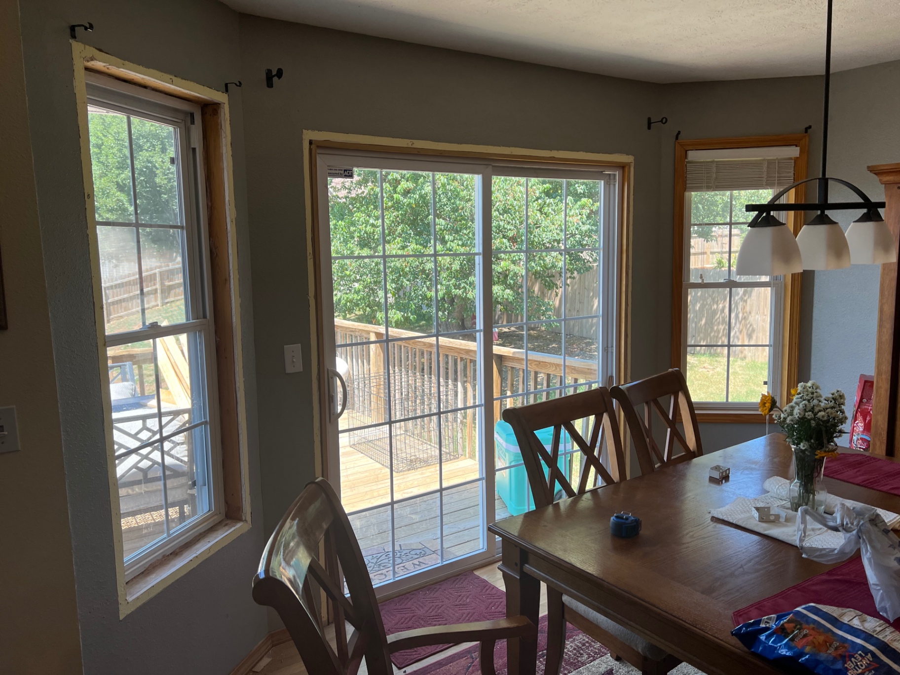 Dining room before custom window and sliding door casing installation in the Ozarks
