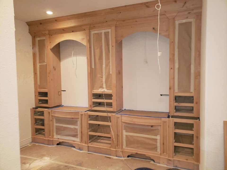 Raw alder built-in entertainment center masked off before staining