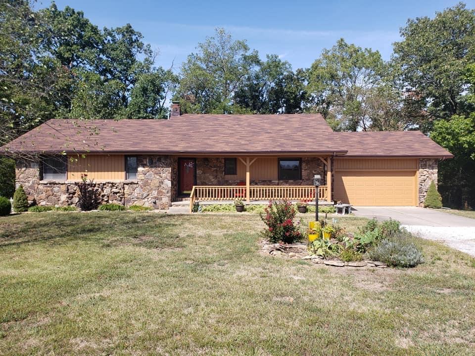 Stone-and-wood ranch home repainted in Springfield, MO