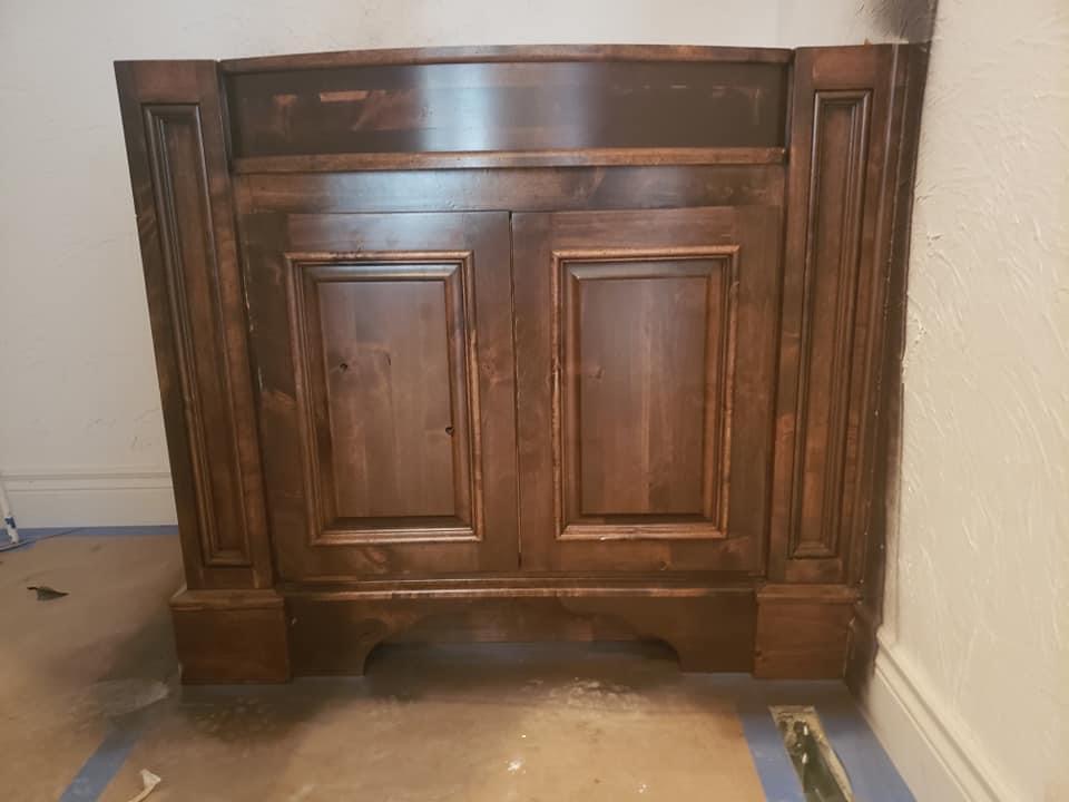 Custom stained bathroom vanity cabinet finished on site in Republic, Missouri