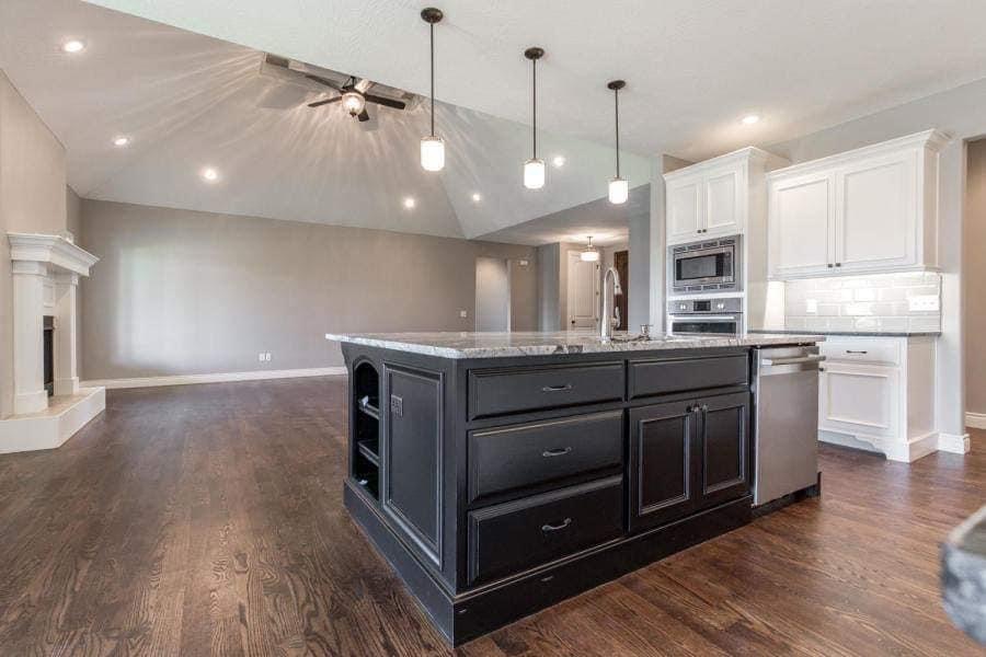 Open-concept kitchen with a charcoal refinished island in Nixa, Missouri