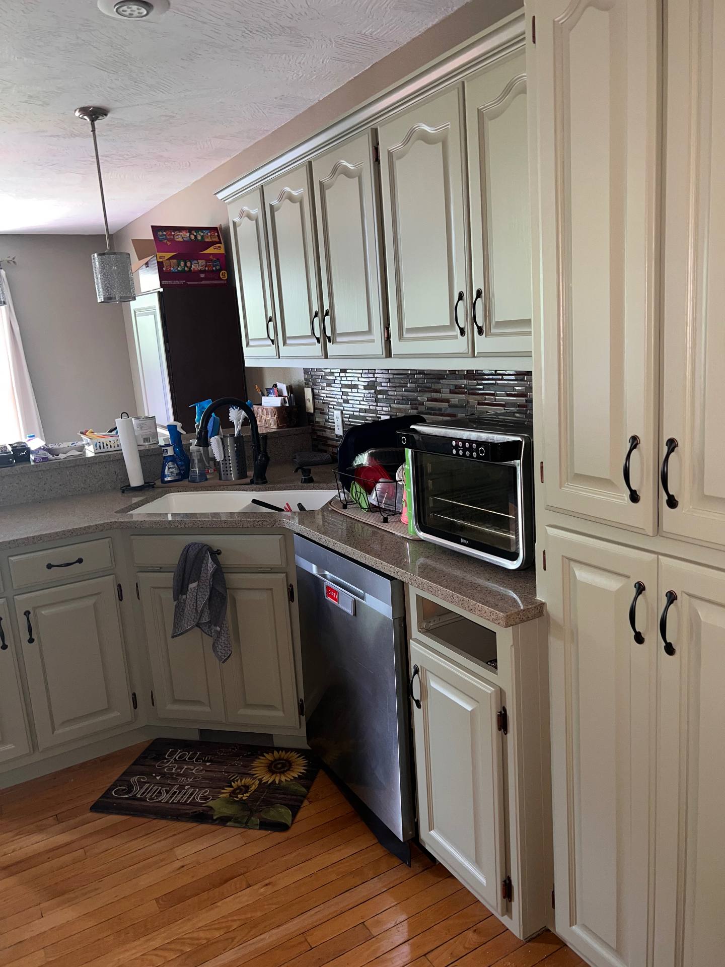 Sage painted kitchen cabinets and pantry in Ozark, Missouri