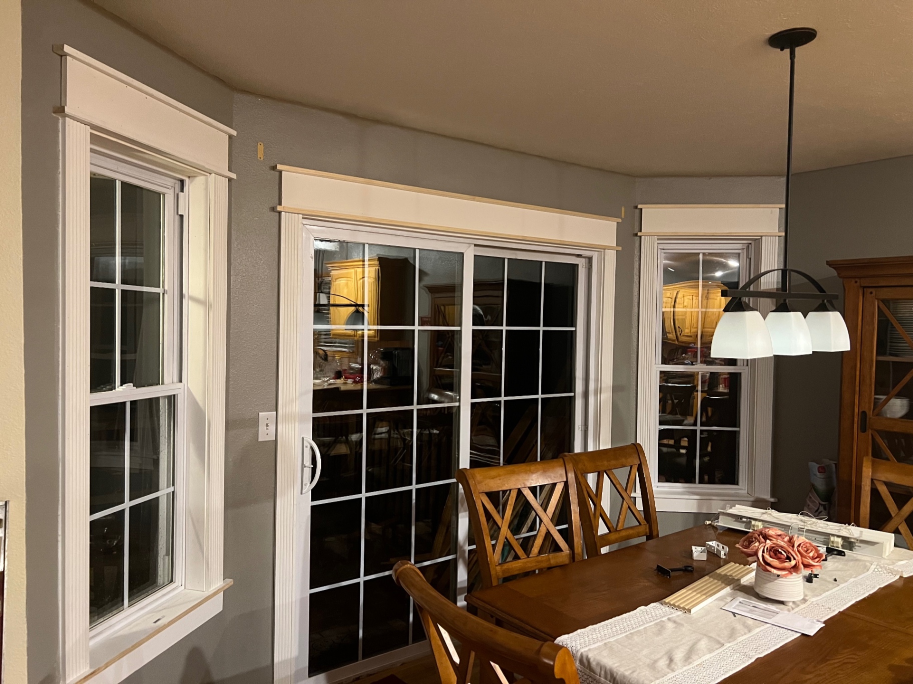 Finished white craftsman window and patio door trim in a Springfield area dining room